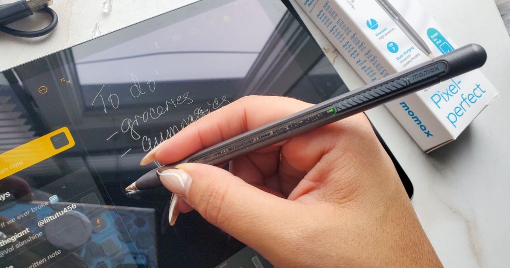 Person using a MOMAX Stylus Smart Pen / Pencil for iPads to write on their iPad