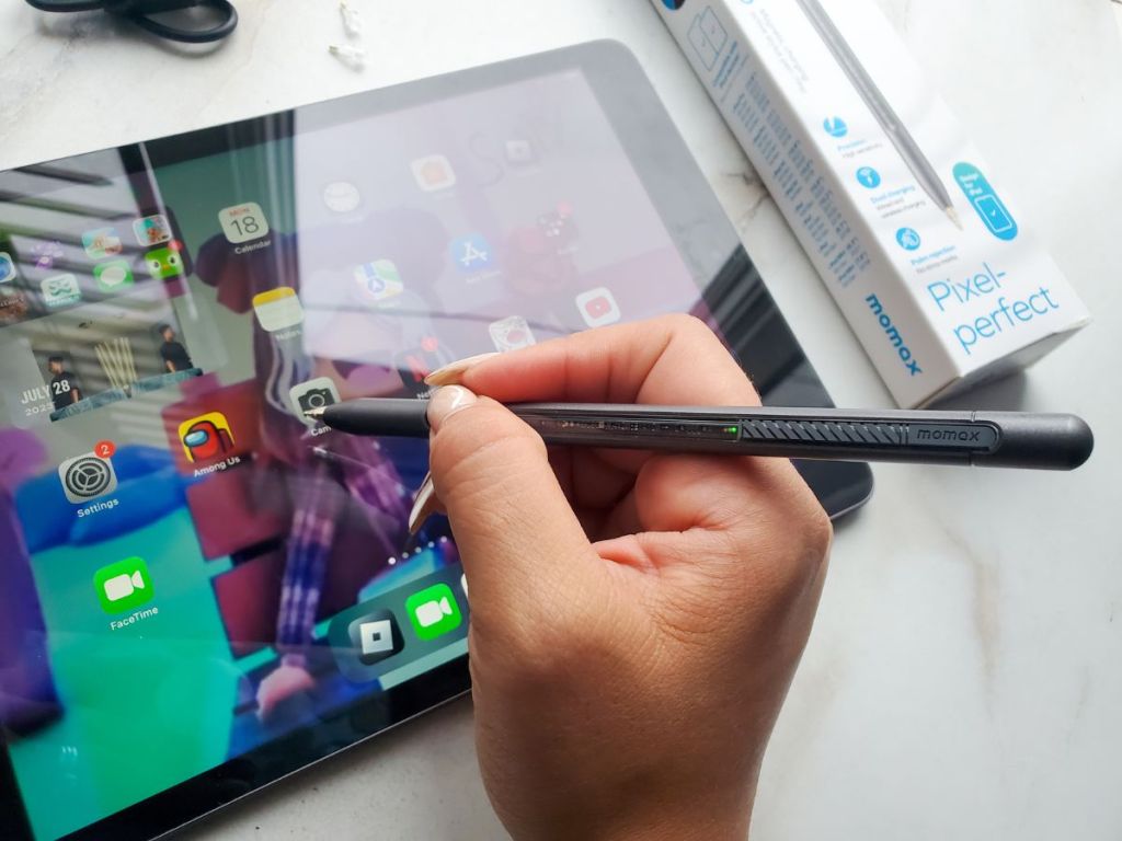 person using a MOMAX Pencil Perfect Stylus Smart Pen / Pencil for iPad