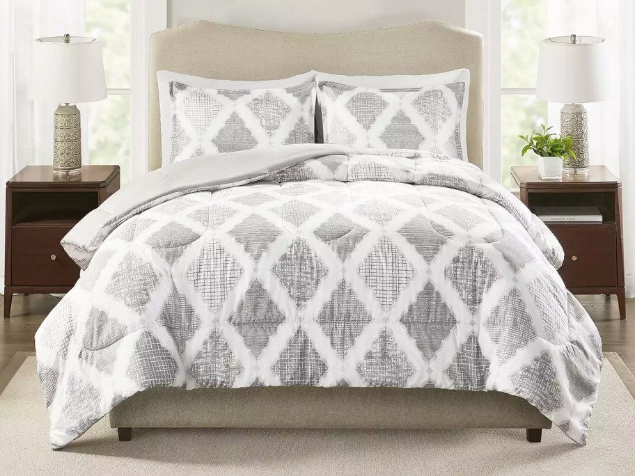 white and grey medallion print comforter set on bed