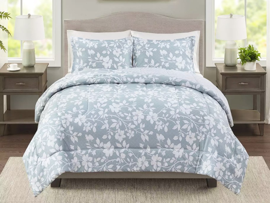 blue and white floral print comforter set on bed