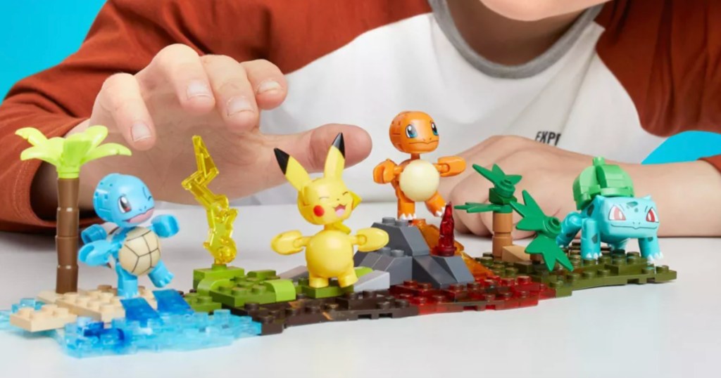 little boy playing with Mega Construx Pokemon Kanto Region Team 130-Piece Set