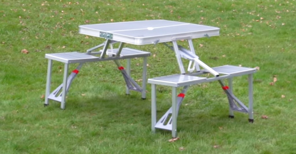 silver folding picnic table on grass