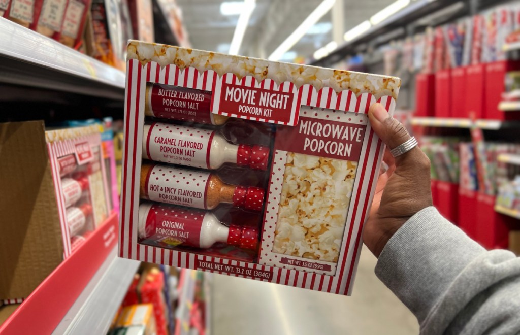 Hand holding up a Movie Night Popcorn Kit from the Walmart gift section