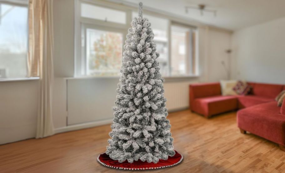 a flocked tree in a living room