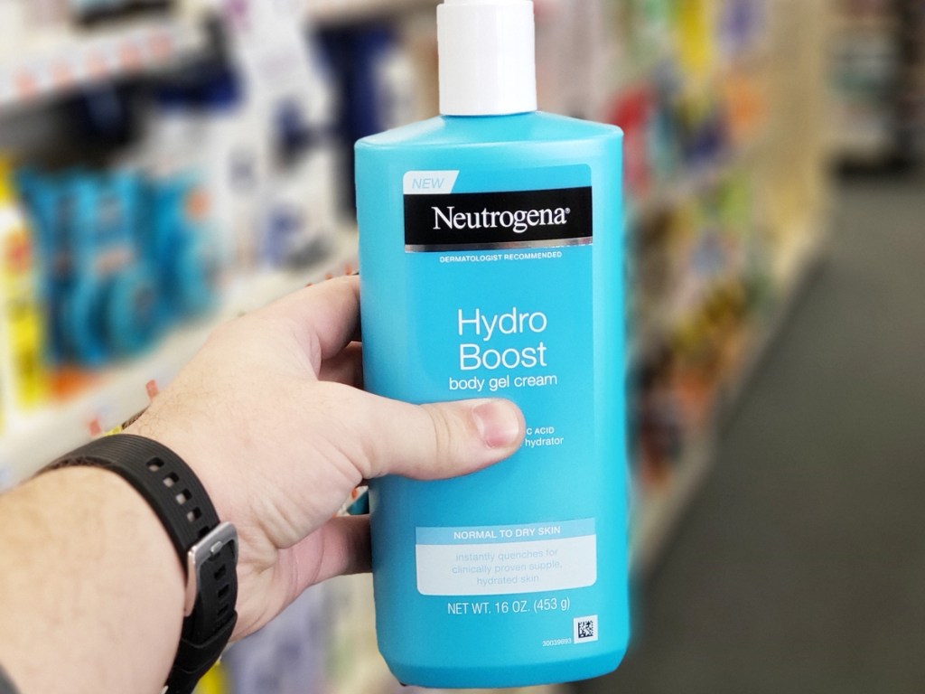 hand holding blue bottle of Neutrogena Hydro Boost Body Moisturizing Gel Cream