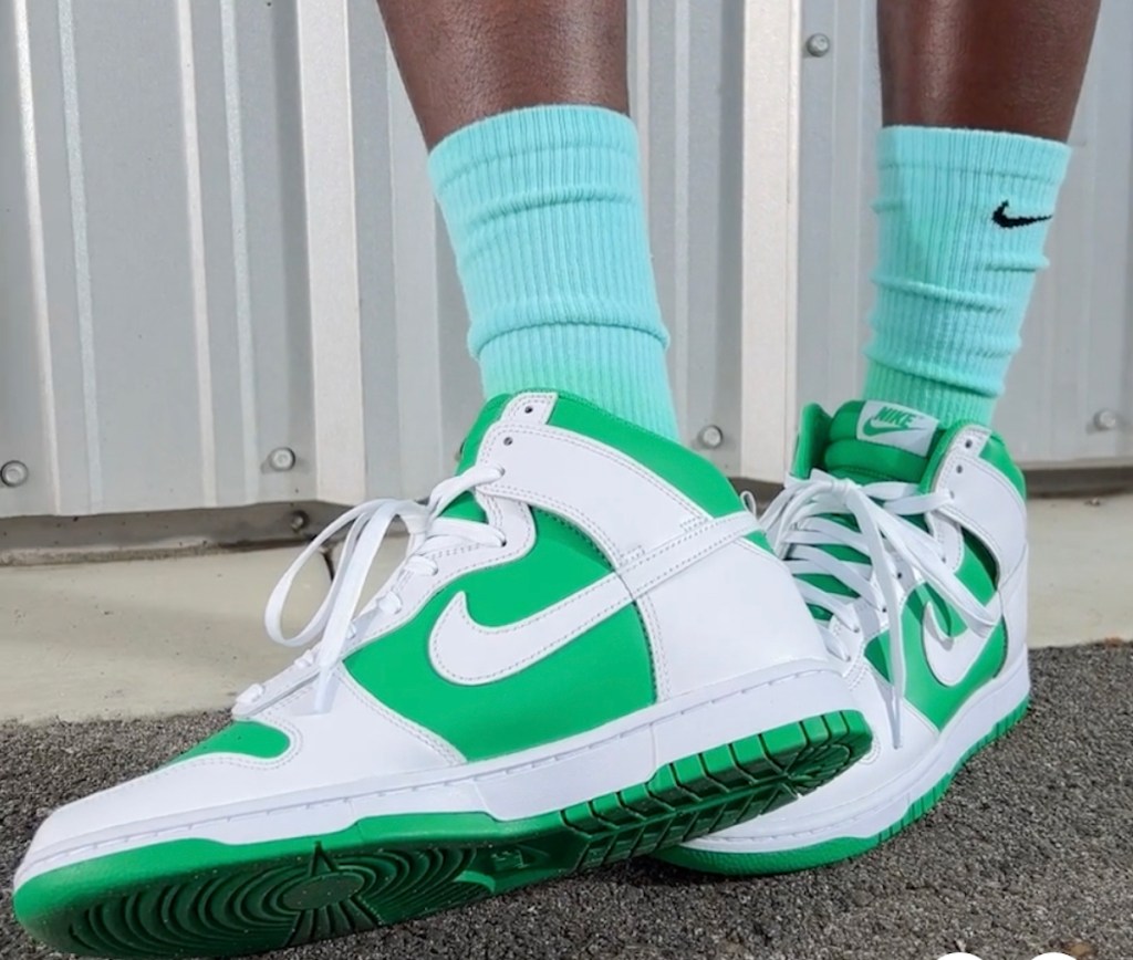 close up of white and green nike dunk retro shoes