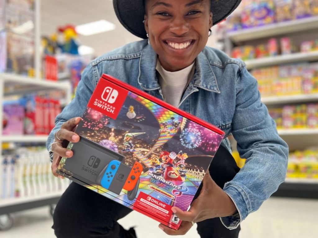 A woman holding Nintendo Switch with Mario Kart 8