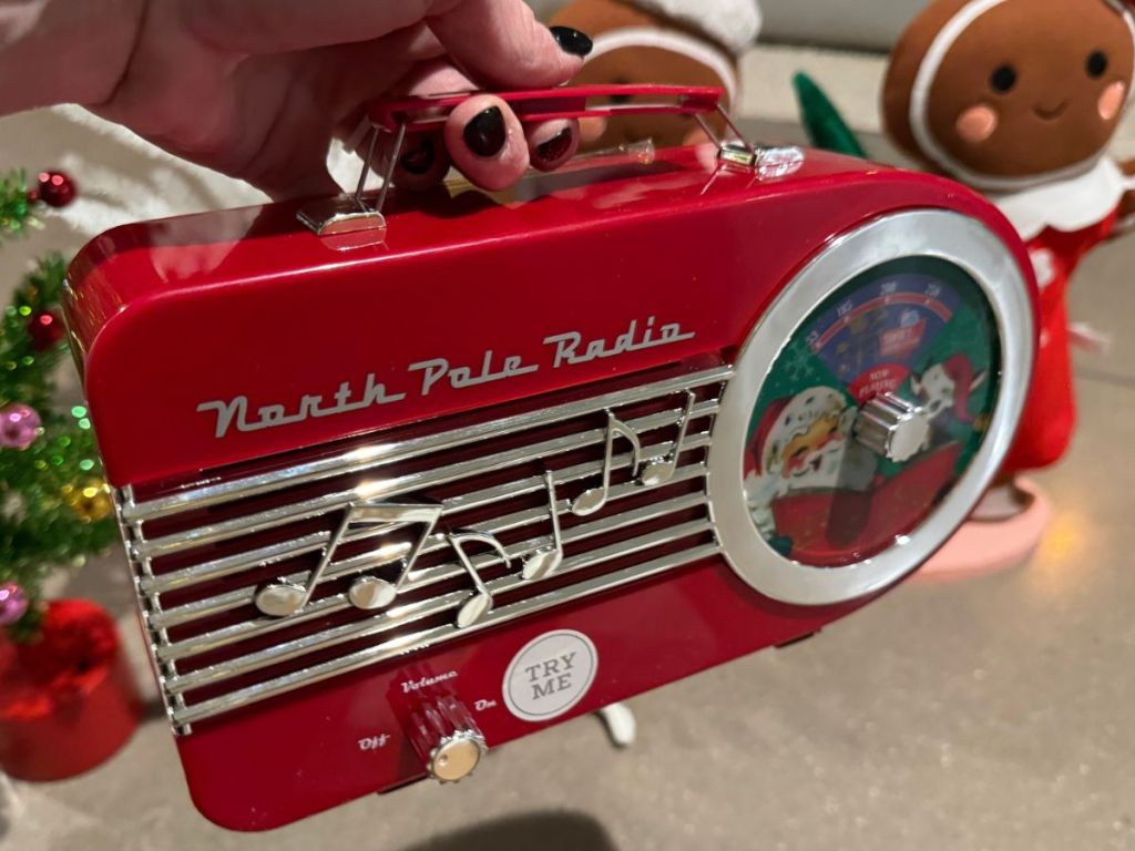 Hand hlding a retro style north pole radio toy