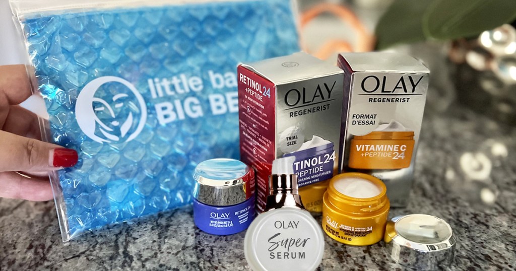 olay travel size products on counter with blue travel pouch