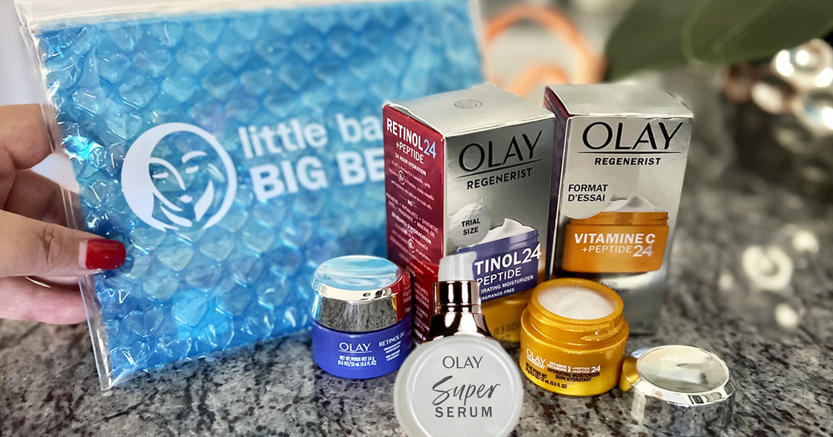 olay travel size products on counter with blue travel pouch