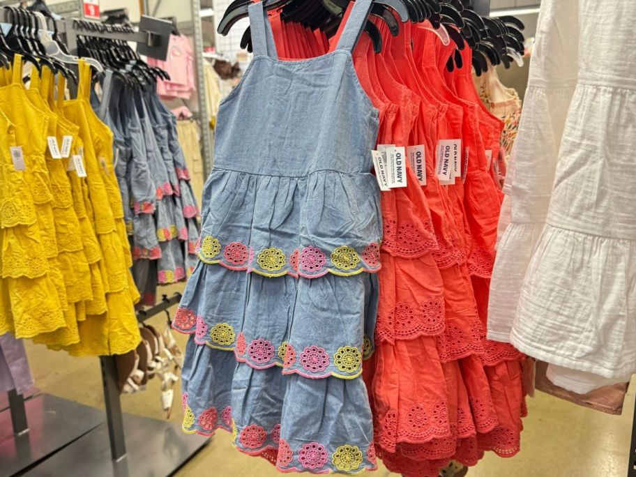 A Girls eyelet dress hanging on a rack at Old Navy