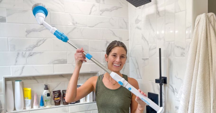 woman holding blue and white scrubber in shower