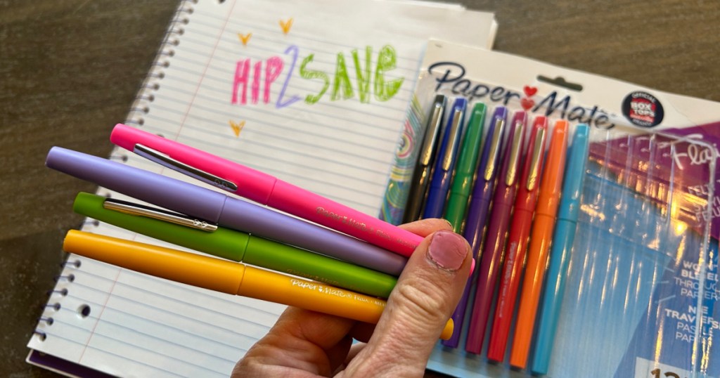 woman holding papermate flair pens