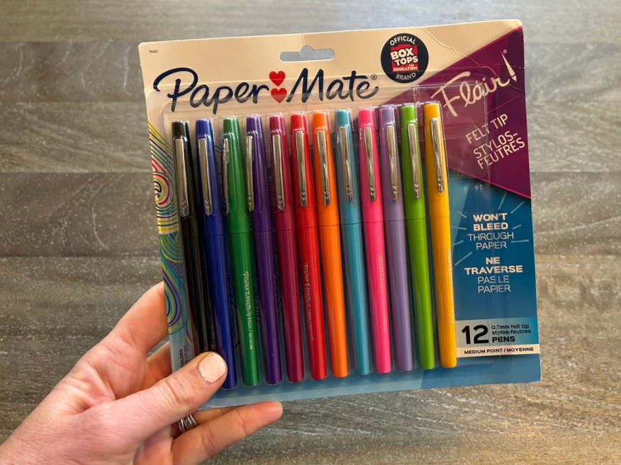 person holding up 12 pack of Papermate Flair Pens