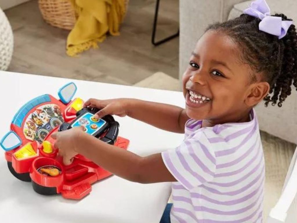 Little girl playing with the VTech PAW Patrol Rescue Driver ATV & Fire Truck