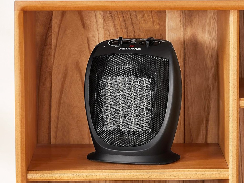 black portable heater in a wood cubby