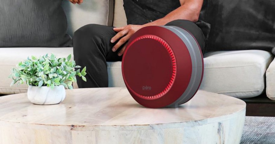 round red air purifier on coffee table