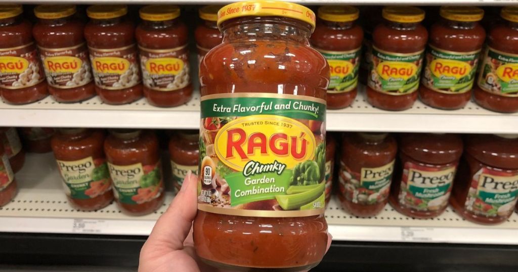 Hand holding a jar of Ragu Garden Combination pasta sauce