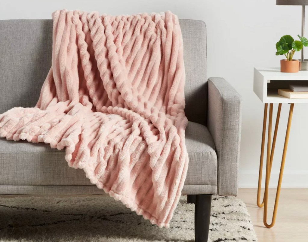 Pink ribbed, blanket draped, over modern gray 