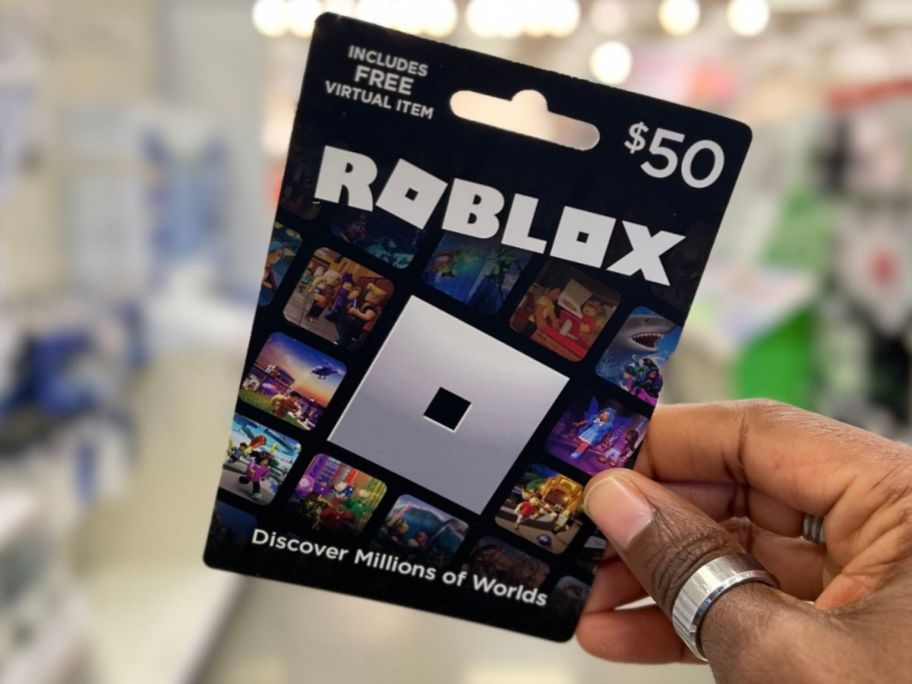 Hand holding a $50 Roblox Gift Card