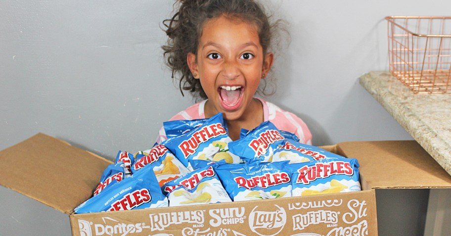 girl holding a box full of ruffles chips