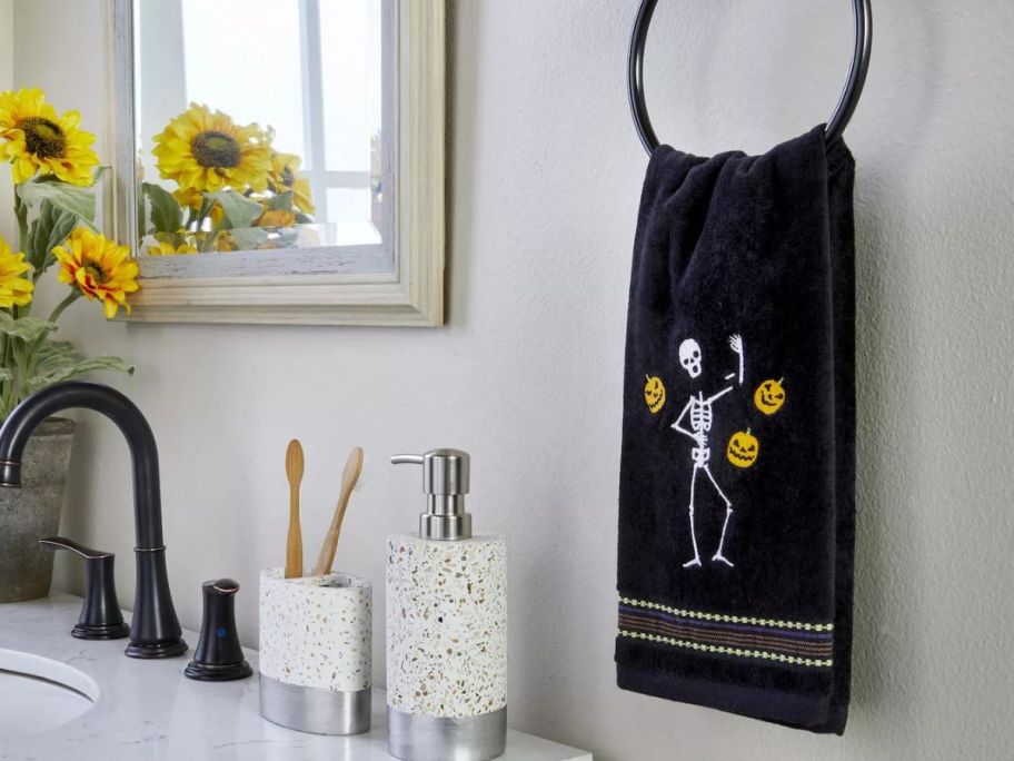 SKL Home Juggling Skeleton 2-Piece Hand Towel Set hanging in bathroom