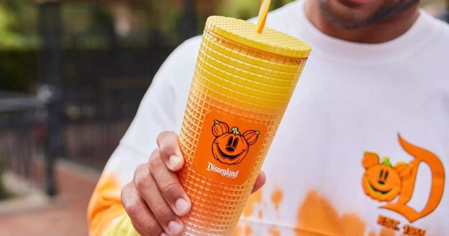 Man holding a Disney Starbucks Halloween Tumbler