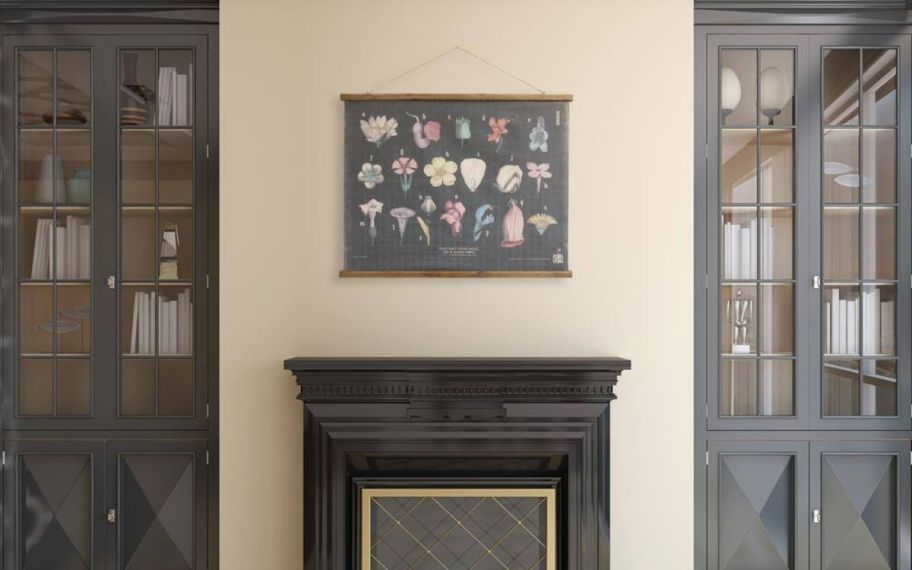 a wood scroll print hanging above a fireplace