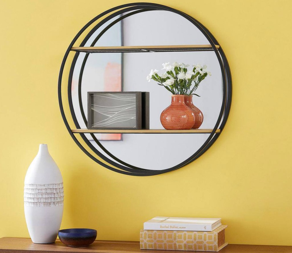 round mirrored wall bookshelf on yellow wall