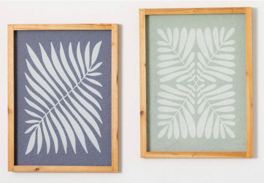 a pair of two fern prints on a wall