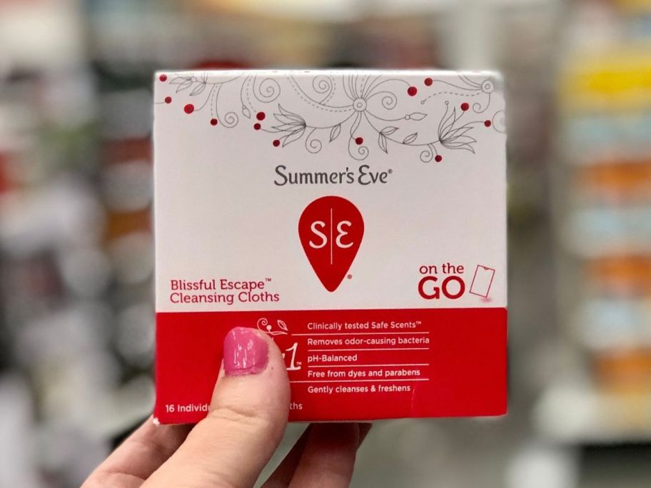 hand holding up a box of Summer's Eve Wipes
