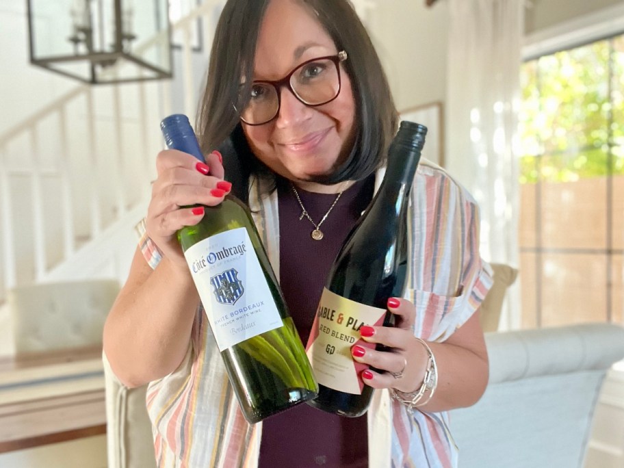 woman holding 2 bottles of wine from swirl wine