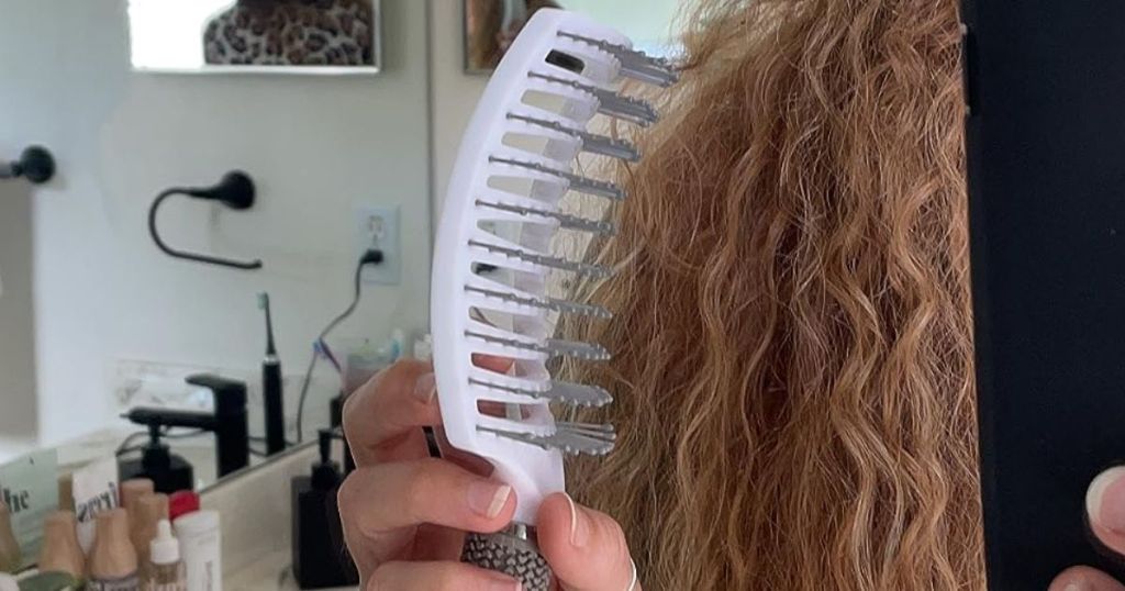 Woman using a Taibest Hairbrush