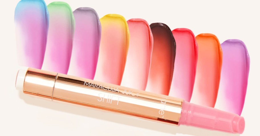 tube of color changing lip gloss with different swatches behind it