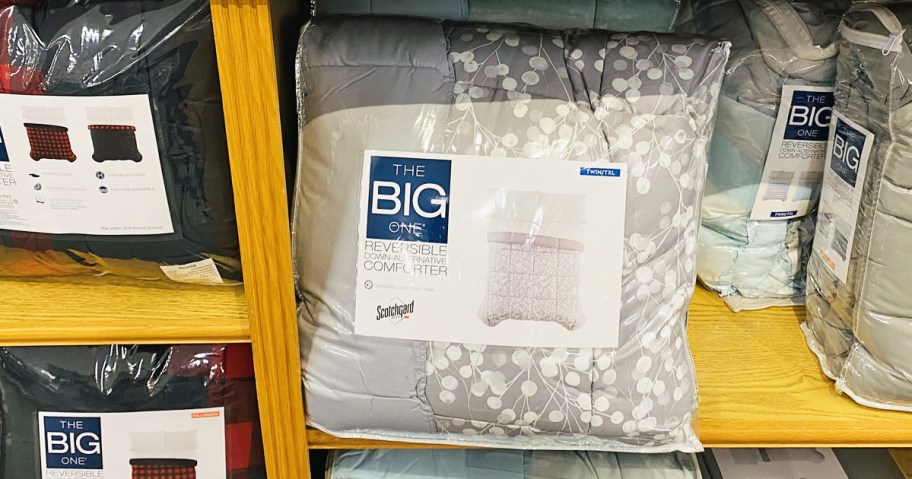 grey The Big One Down-Alternative Reversible Comforter set on wood shelf in store
