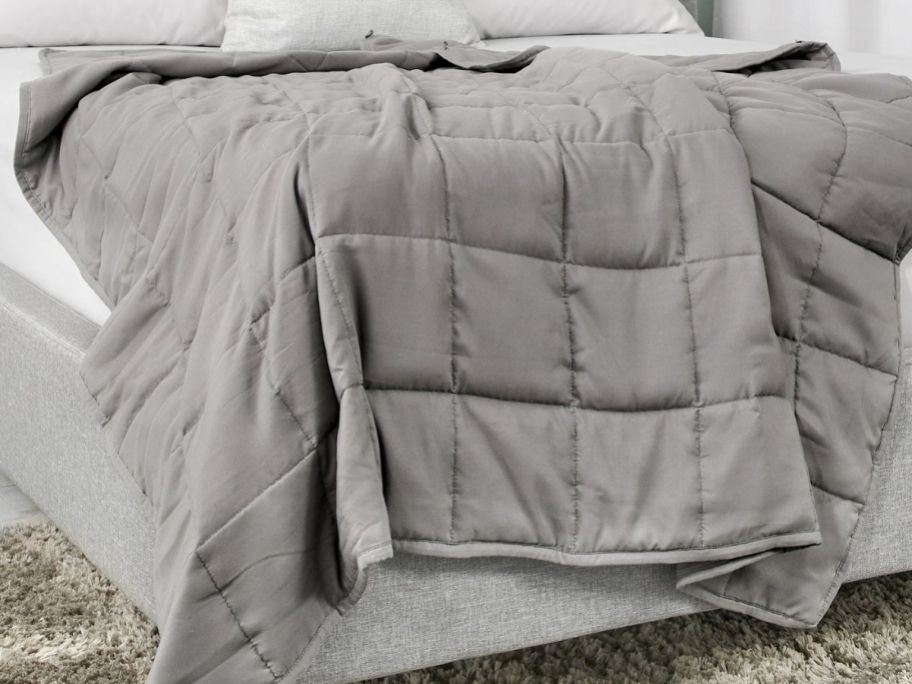 Tranquility Antimicrobial Quilted Weighted Blanket on a bed