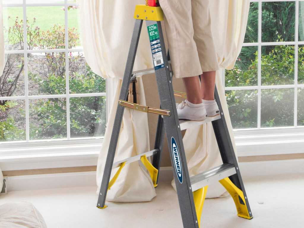 Werner 4-ft Fiberglass Step Ladder Type 2 with a person standing on it