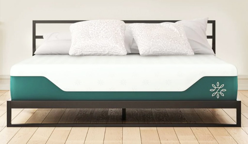 white and green mattress on a black metal bed frame