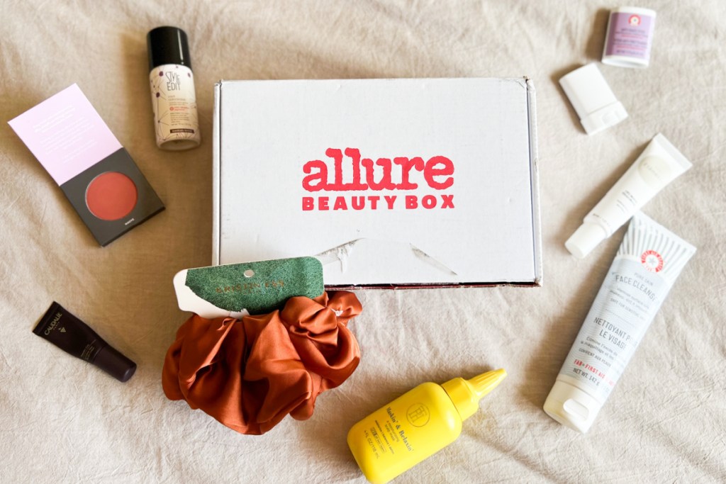 allure beauty box with products around it