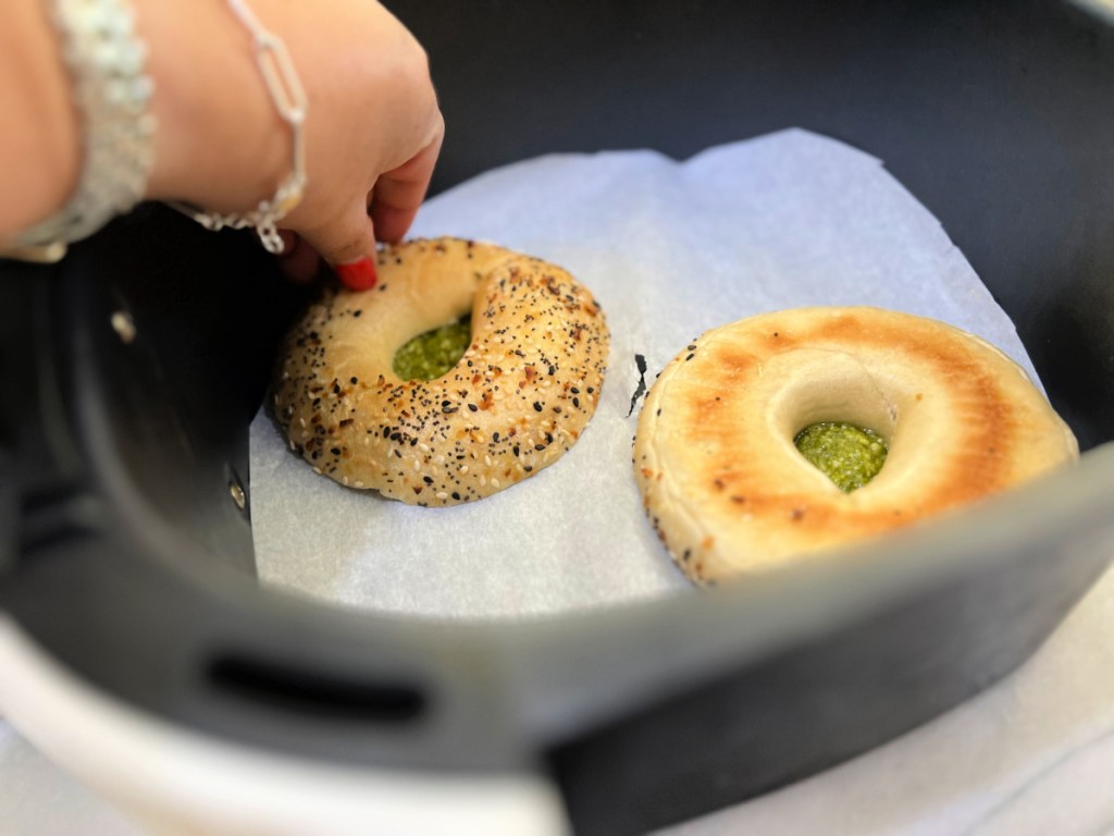bagel with pesto on parchment paper