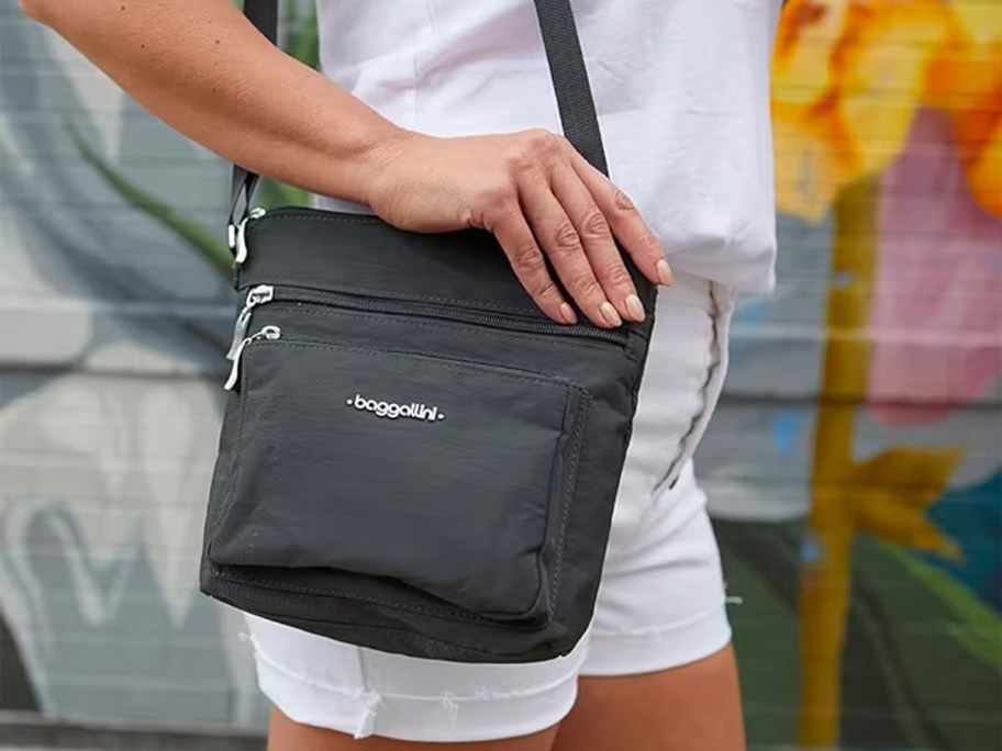 woman wearing black baggallini crossbody bag