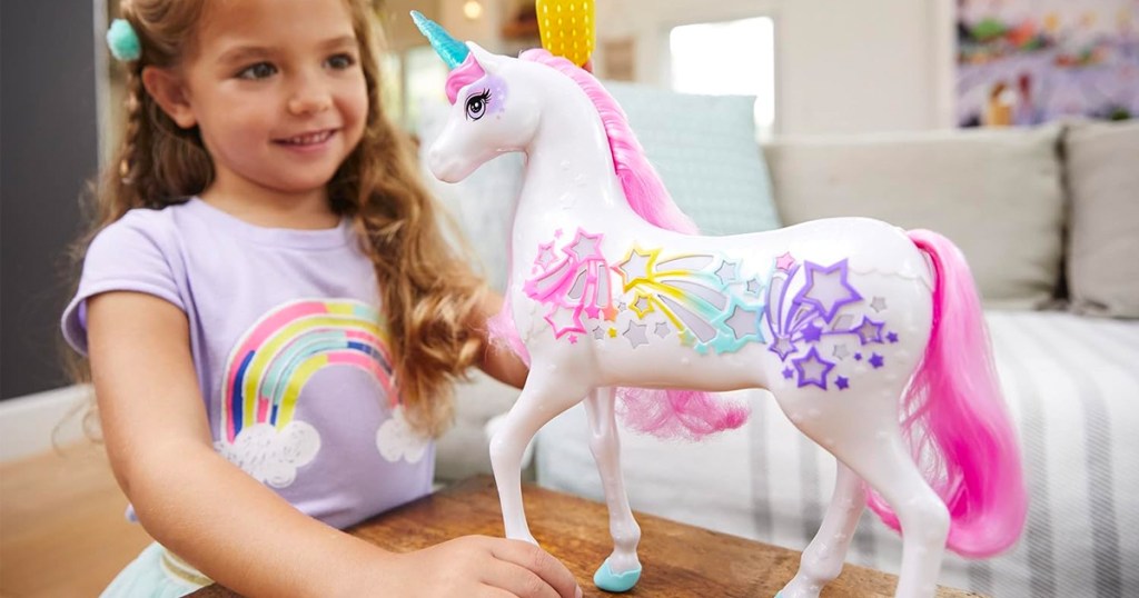 child playing with unicorn toy