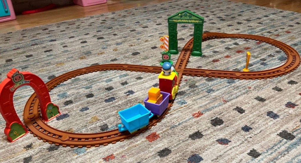cocomelon train toy display on the carpet