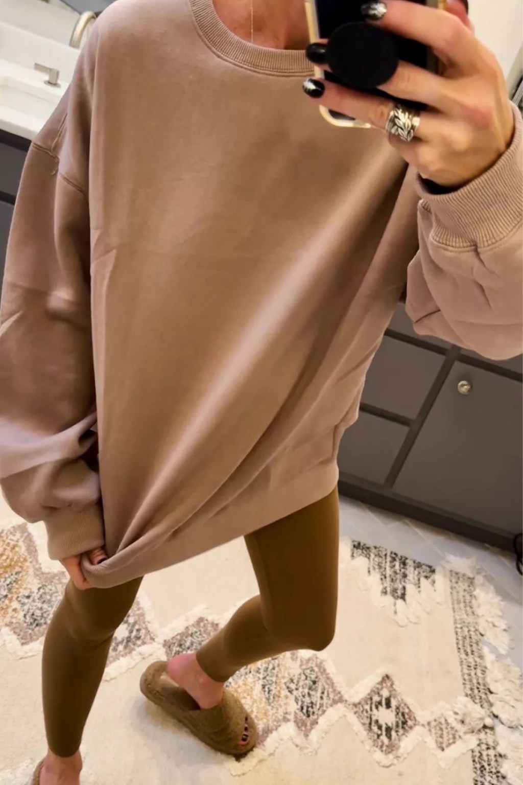 woman wearing oversized brown sweatshirt