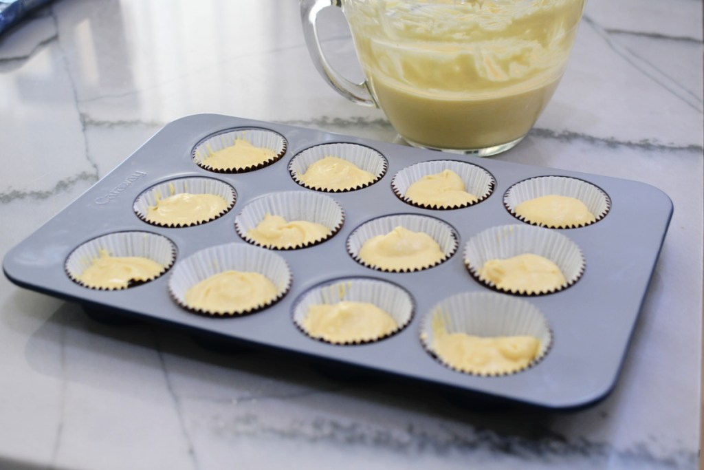 cupcake pan with batter ready for the oven