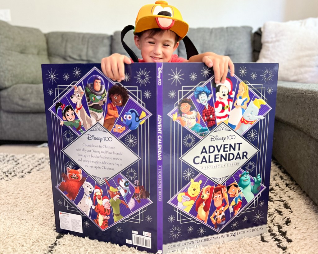 boy with pluto hat behind advent calendar