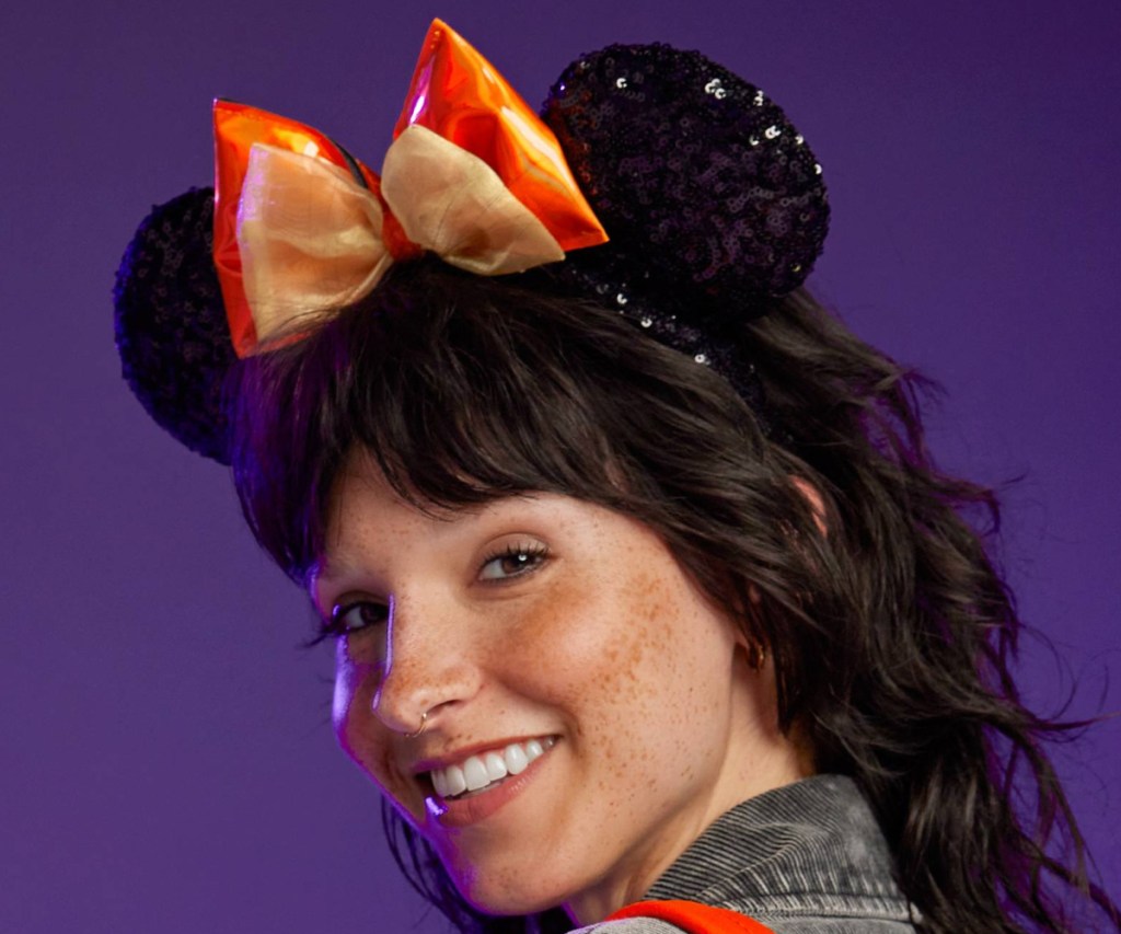 woman wearing minnie mouse orange bow ear headband