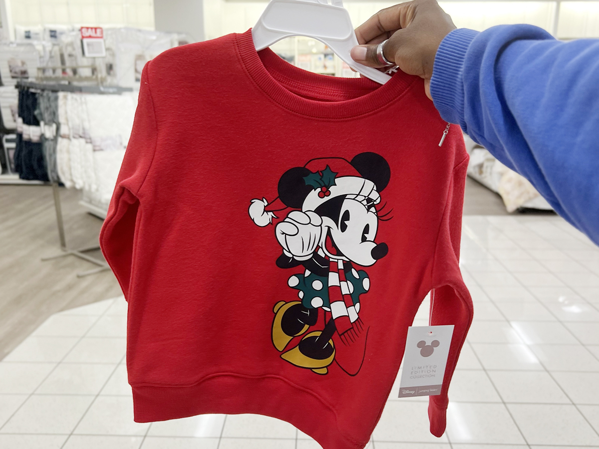 hand holding red minnie mouse sweater