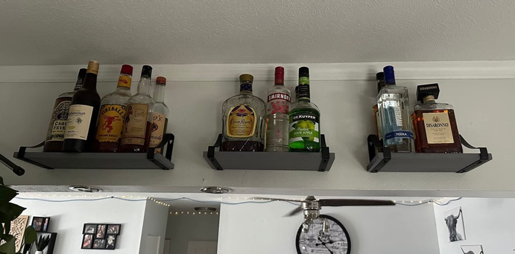 display of hanging shelves with alcohol bottles on them