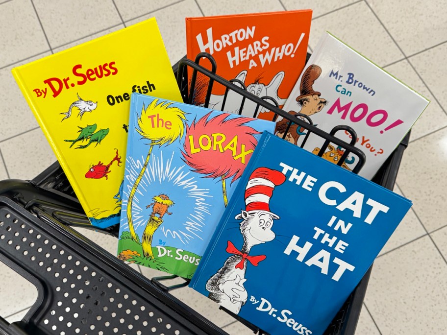 five dr suess books sitting in shopping cart